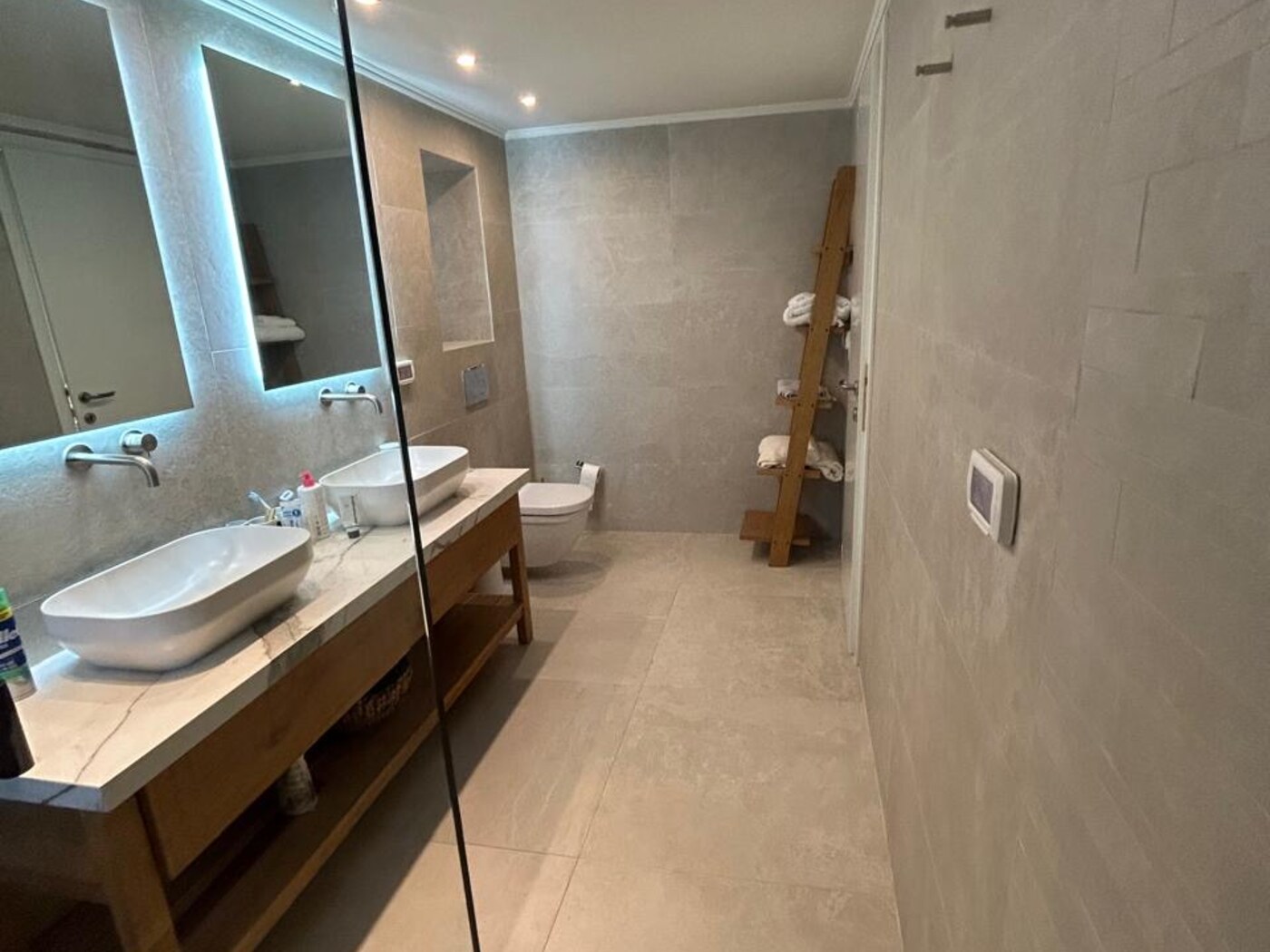 Master en-suite bathroom — large-format stone, double vanity