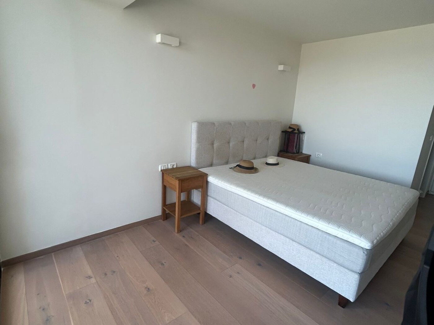 Master suite bedroom — bed with tufted headboard